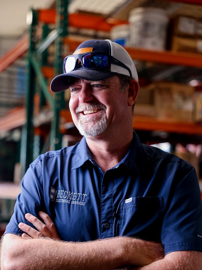 An experienced electrician in his company's warehouse
